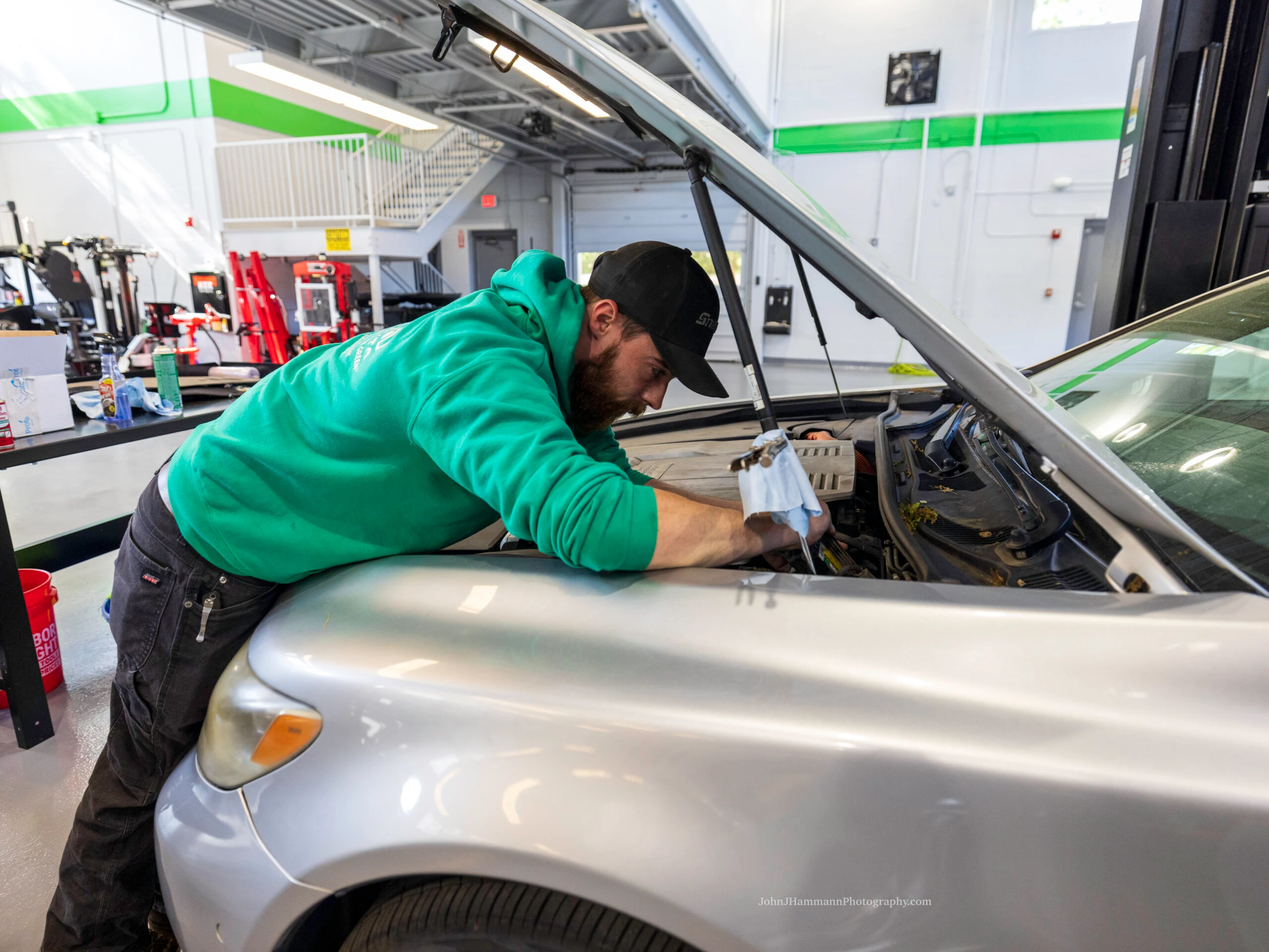 Eco Auto technician using digital technology for vehicle service
