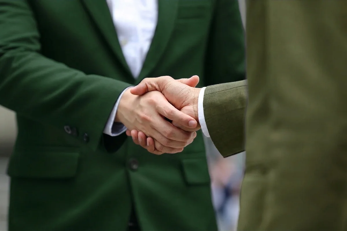 Franchise partnership handshake — joining the Eco Auto family